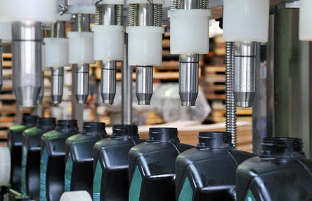 chemical bottles on an assembly line